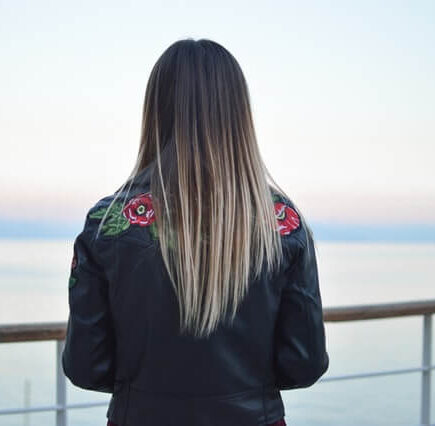 A straight haired woman looking into the distance