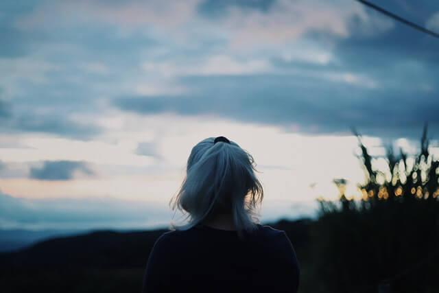 White haired female staring at the horizon
