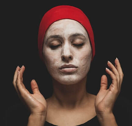 woman with red hijab on her head applies Chemical Exfoliants
