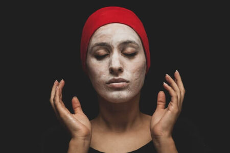 woman with red hijab on her head applies Chemical Exfoliants