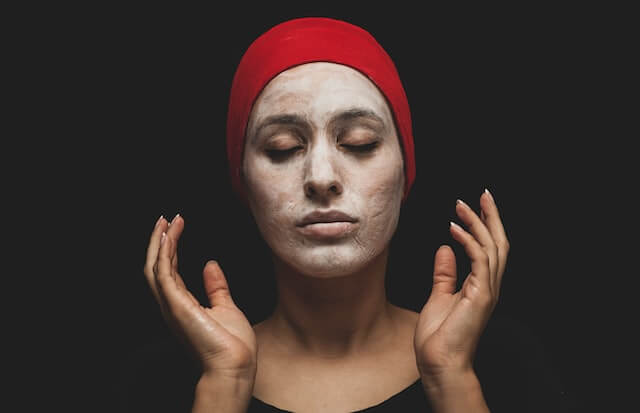 woman with red hijab on her head applies Chemical Exfoliants