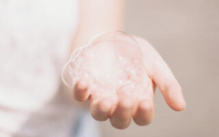 A person holding bubbles from Face Wash