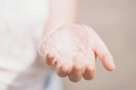 A person holding bubbles from Face Wash
