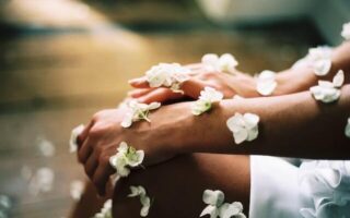Sensitive skin hand surrounded by white flowers