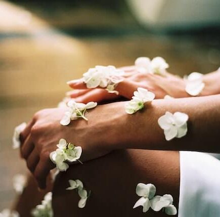 Sensitive skin hand surrounded by white flowers