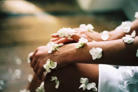 Sensitive skin hand surrounded by white flowers