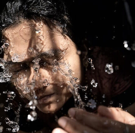 A person washing his face